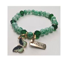 a green beaded bracelet with a gold charm and a name tag that says imagine