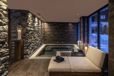 a living room filled with furniture and a hot tub in the middle of it's walls