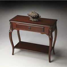 a small wooden table with a drawer on it's side and a vase on top