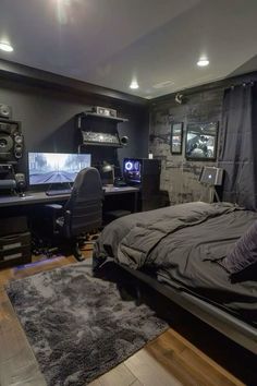 a bedroom with a bed, computer desk and other items in it's room