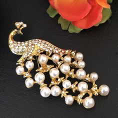 White faux pearls rhinestone peacock brooch Height: 2.7 inch ( 7 cm ) Width: 1.5 inch ( 4 cm ) Condition: Vintage condition Found in: The Netherlands Material: Rhinestone, Gold tone metal, White faux pearls Please know that the items for sale in my shop are vintage pre-owned items, not in their original condition and may show signs of wear due to age and use. There may be minor flaws such as light scuffs, tarnish, color fade, scratches, etc. View the photos to evaluate the condition Your item wi Elegant Party Brooch With Peacock Design, Wedding Brooch With Peacock Design, Elegant Peacock Design Brooch For Wedding, Elegant Wedding Brooch With Peacock Design, Elegant Peacock Design Wedding Brooch, Elegant Peacock Design Brooch For Formal Occasions, Elegant Peacock Design Brooch For Formal Wear, Monkey Jewelry, Peacock Brooch