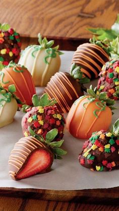 chocolate covered strawberries with sprinkles and leaves on a white paper towel