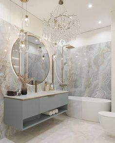 a bathroom with marble walls and flooring, a chandelier hanging from the ceiling