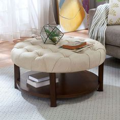 a living room with a couch, coffee table and books on the end tables in it