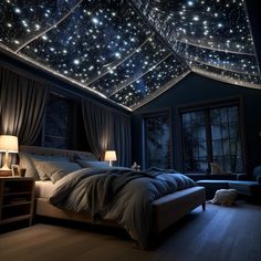 a bed sitting under a sky filled with stars next to a night sky light fixture