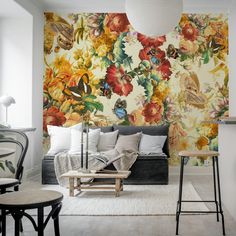 a living room with floral wallpaper and furniture