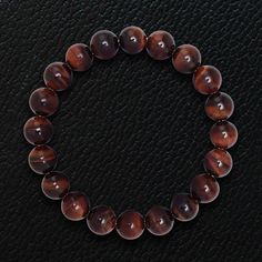 Our spiritual Himalayan Beads bracelets are meticulously handcrafted using high grade certified natural gemstones. Meaningful and healing, powers of our precious and semi-precious gemstones are enhanced by a purification process to maximize their spiritual powers. Discover unique mens designs in powerful gemstones for an immediately uplifting statement of spirits and style. Iron Tiger Eye beads, 10mm Stretch Bracelet Sleek gift box included Iron Tiger Eye is a stone of strength, stamina and cour Brown Crystal Bracelet With Gemstone Beads, Brown Gemstone Bracelets, Brown Gemstone Round Bracelets, Beaded Bracelet For Men, Gemstones And Crystals, Spiritual Symbols, Red Tigers Eye, Beads Bracelets, Colored Stones