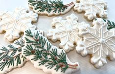 three decorated christmas cookies sitting on top of a table