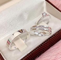 two wedding rings sitting in a box