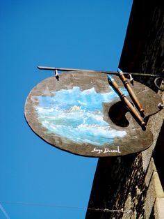 a sign on the side of a building that has been painted with blue and white paint