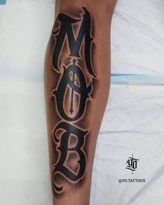 a man with a tattoo on his leg that says b o b and has an arrow in the middle