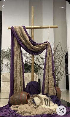 a purple and beige canopy bed in a room