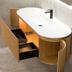 a bathroom sink with an open drawer underneath it