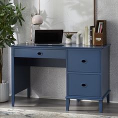 a blue desk with a laptop on it