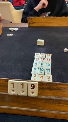 an old wooden board game with numbers and dices