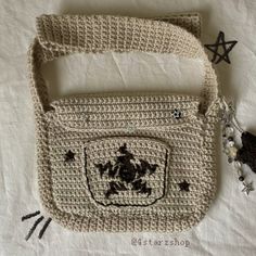 a crocheted purse with a turtle on the front and star decorations around it