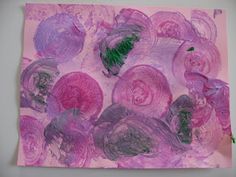 an abstract painting with pink and purple flowers on a white background in the process of being made