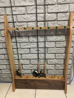 a wooden rack with several bottles on it in front of a brick wall and wires