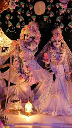 two women dressed in elaborately decorated costumes