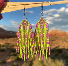 Handcrafted seed bead earrings, made by hand in our Colorado jewelry studio.  Purple and Green Beaded Fringe Earrings. Hand Crafted using glass seed beads. Stainless steel hook ear wires. Southwest, Western and Desert boho style. Limited Edition. Check out our other styles and follow us on Instagram to see what is new @monstera_metalworks Southwestern Green Earrings With Colorful Beads, Southwestern Style Green Earrings With Colorful Beads, Handmade Southwestern Green Beaded Earrings, Southwestern Green Beaded Dangling Earrings, Southwestern Green Beaded Dangle Earrings, Southwestern Green Earrings With Dangling Beads, Desert Jewelry, Earrings Handmade Boho, Desert Boho