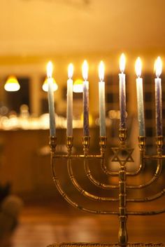 a menorah with lit candles in the middle