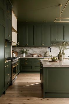 a kitchen with green cabinets and wooden floors