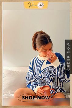 a woman is sitting on a bed with her hand in her mouth