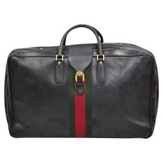 a black leather duffel bag with red, green and yellow stripe on the side