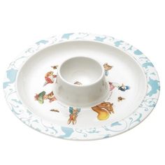 an empty cup and saucer sitting on top of a white plate with blue designs