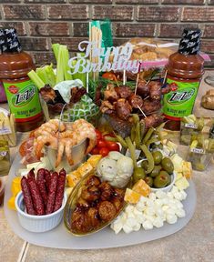 a platter filled with assorted foods and condiments for a birthday party