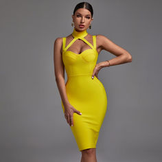 a woman in a yellow dress posing for the camera with her hands on her hips