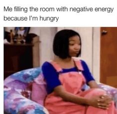 a woman sitting in a chair with the caption me filling the room with negative energy because i'm hungry