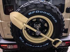 a close up of a tire on a vehicle with a shovel attached to the tire