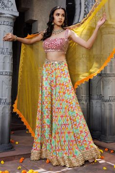 Pink, yellow, multicolor lehenga with geometric print all over and embroidered border. Paired with mirror, pearl, beads, dori embroidered padded blouse and dupatta.
Components: 3
Pattern: Printed, Embroidery
Type Of Work: Geometric, mirror, pearl, bead, dori
Neckline: Sweetheart neck
Sleeve Type: Sleeveless
Fabric: Crepe
Color: Multi Color
Other Details: 
Lehenga:
Geometric pattern
Embroidered border
Approx. product weight: Less than 2 kgs
Blouse:
Padded
Pearl drops on hem
Dupatta:
Cutwork embro Festive Lehenga With Printed Motifs For Parties, Party Lehenga With Printed Motifs For Festivals, Festival Party Lehenga With Printed Motifs, Multicolor Party Lehenga With Printed Motifs, Multicolor Georgette Dupatta For Reception, Multicolor Georgette Sets For Navratri, Multicolor Semi-stitched Georgette Choli, Party Choli With Printed Motifs For Festivals, Multicolor Anarkali Set With Zari Work For Summer