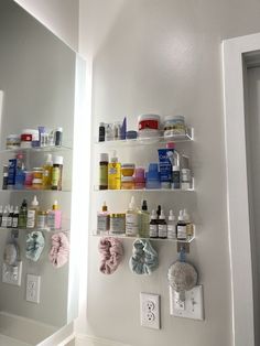 the shelves are filled with different types of medicine and personal care products on display in this bathroom