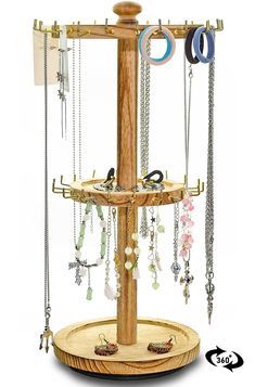 a wooden jewelry stand with several necklaces hanging from it's sides and two rings on the top