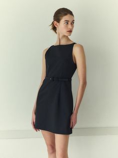 This elegant sleeveless dress showcases a refined design with its structured fit and minimalist style. It features a square neckline that lends a modern edge, complemented by precise darting at the bust and waist to enhance the silhouette. A slim, detachable belt with a subtle buckle accentuates the waist, offering a tailored look. The dress is secured with a concealed zipper at the back, ensuring a sleek and uninterrupted profile.- The square neckline and structured darts create a sophisticated and contemporary appearance, suitable for professional and formal settings.- The inclusion of a detachable belt allows for versatility in styling, providing an option to either emphasize the waist or opt for a more streamlined silhouette without the belt.- Its solid color and classic design make it Square Necklines, Minimalist Style, Square Neckline, Mini Black Dress, Minimalist Fashion, Classic Design, Sleeveless Dress, The Dress, Sleek