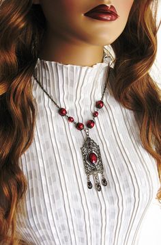 Red Victorian Style Necklace, handmade by Ralston Originals. This red pearl necklace is made with a large antique gold pendant, with red cabochon center, and 3 small charm dangles in antique gold with red crystals. The pendant is 3.5 inches long including the dangles, and 1 inch wide. The pendant is on antique gold brass chain, with dark red glass pearl beads, and antique gold bead caps. This Victorian red necklace is 18 inches long. This necklace is ready to send today, and it includes free shi Vintage Red Jewelry With Dangling Beads, Antique Red Handmade Necklaces, Vintage Red Pendant Beaded Necklace, Vintage Red Beaded Pendant Necklace, Antique Red Beaded Necklaces For Gift, Antique Red Beaded Necklace For Gift, Red Vintage Necklace With Dangling Beads, Vintage Red Necklace With Dangling Beads, Antique Red Handmade Necklace