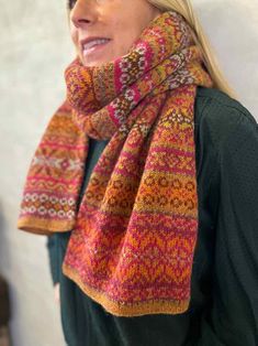 a woman wearing a multicolored knitted scarf