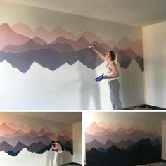 a woman painting a wall with mountains painted on the walls and another person using a paint roller