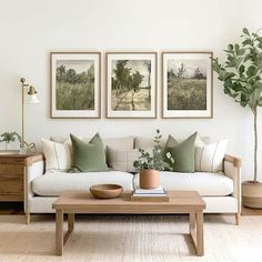 a living room with three pictures on the wall and a coffee table in front of it