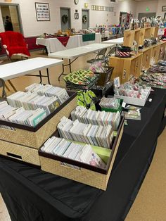 a long table covered in lots of cards and folders