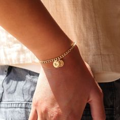 Add a personal touch with our Demi Alexandra Personalized Bracelet. Made with a 14k gold fill chain, this bracelet features stamped discs customized with your choice of personalization. Perfect for anyone looking for a unique, sentimental accessory! DETAILS14k gold fillBracelet Sizing: XS=5.5", S=6", M=6.5", L=7", XL=7.5"Hypoallergenic, water proof, and nickel free To measure your wrist size, wrap a piece of string around your wrist the way you would like the bracelet to fit. Then lay the string Personalized 14k Gold Hypoallergenic Bracelets, Personalized 14k Yellow Gold Charm Bracelet, Personalized Dainty Yellow Gold Bracelet, 14k Gold Name Bracelet For Personalized Gift, 14k Gold Round Name Bracelet For Personalized Gift, Dainty 14k Gold Personalized Charm Bracelet, Dainty Personalized 14k Gold Charm Bracelet, Personalized 14k Gold Name Bracelet, Personalized 14k Gold Bracelet For Mother's Day