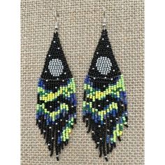 the beaded earrings are black, yellow and blue with beads on it's sides