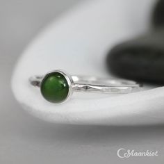 This delicate Green Jade Promise RIng features a 6 mm smooth cabochon that has been carefully set in a highly polished fine silver bezel. The band is made of a sturdy round Sterling Silver wire that has been given a hammer texture, then carefully polished for a bright finish. Our setting process involves carefully tightening the fine silver bezel down around the stone, then beveling at the edge of the bezel to further compress the silver, creating a water-tight seal with no stone movement. These Modern Jade Cabochon Jewelry, Modern Jade Ring As A Gift, Oval Cabochon Jewelry With Smooth Bezel For Gift, Minimalist Oval Cabochon Ring With Bezel Setting, Stackable Rings With Smooth Bezel For Gift, Green Cabochon Moonstone Ring, Elegant Green Cabochon Moonstone Ring, Promise Ring Simple, Opal Ring Simple