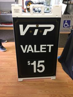 a black and white sign that says vrp valet $ 15