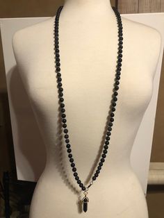 "8mm round, 108 bead mala 3'4\"- large size with Onyx pendulum. Matte Onyx (Shiny Onyx Pendulum), larvikite, lavastone, and Galaxy cats eye(Tigers eye) beads. For Divination and meditation." Galaxy Cat, 108 Mala Beads, 108 Bead, Tiger Eye Beads, Cats Eye, Eye Beads, Tigers Eye, Mala Beads, Shades Of Black