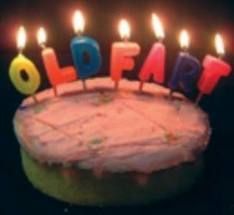 a birthday cake with lit candles that spell out the word happy