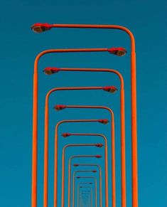 an orange street light with many red lights on it's sides and the sky in the background