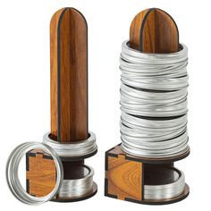 two wooden and metal objects are stacked on top of each other, with one ring in the middle